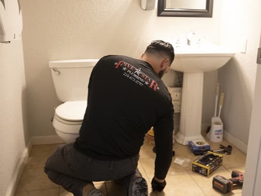 Licensed Five Star Plumbing professional at work in a bathroom