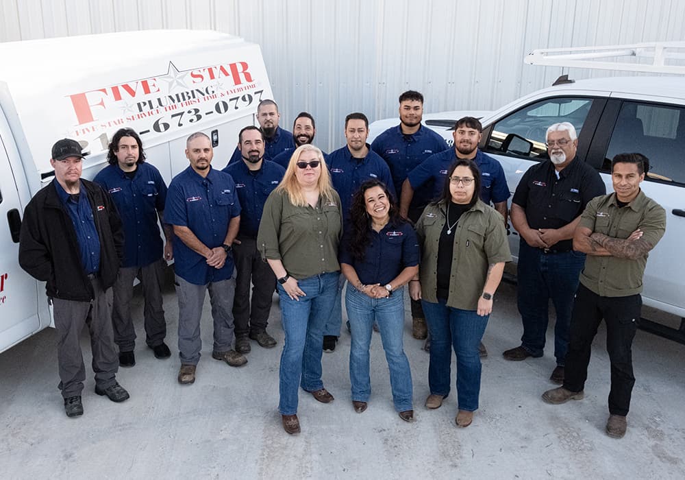 Five Star Plumbing team standing together in front of service trucks